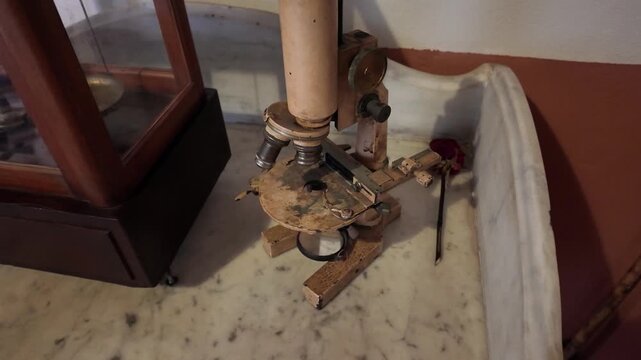 Antique German Microscope testament to early medical research, detailed scientific tool of past era. Made by Carl Zeiss Jena with three-lens revolver and a horseshoe foot.