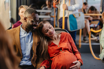 Pregnant couple traveling on bus, embracing love and happiness