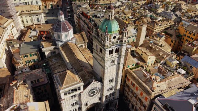 Drone advancing toward San Lorenzo Cathedral in Genoa, performing a tilt down to the parvis on a sunny day.
