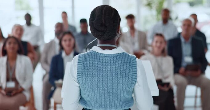 Back, business and woman with speech for audience for conference, training and upskill pitch. Female person, talking and staff listening to discussion, corporate event and lecture at learning seminar