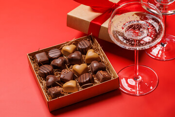 A glasses of champagne elegantly paired with a box of rich chocolates