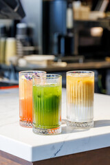Assorted summer lemonades in glass jars with fresh fruits, ice, and garnishes