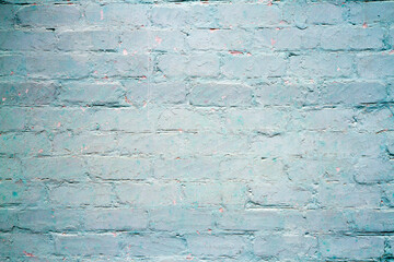 An old brick wall painted with blue paint. Texture of old brickwork