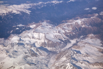 Caucasus mountains with snow peaks in aerial winter scene. Aerial view from plane.