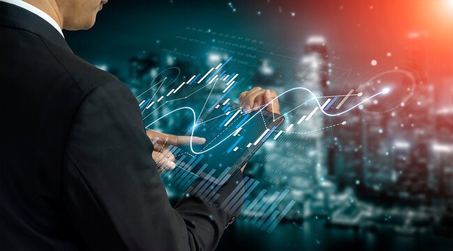 A businessman interacts with a tablet displaying a digital trade chart against a blurred city backdrop, representing growth and market analysis in finance. Scalp