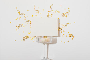 Party New Year or Christmas empty blank background with champagne glass and golden confetti stars....