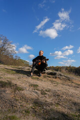 Portrait of smiling caucasian artist plays wooden acoustic guitar in autumnal park. Young songwriter plays string musical instrument hobby outside in nature fall time. Audio music healing in natural