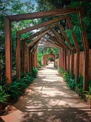 Wooden arch in the park. A path leading to the forest.