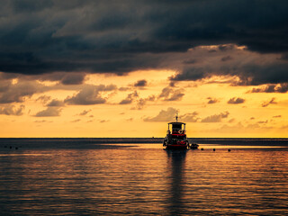 Fishing boat in the sea at sunset. Beautiful seascape.