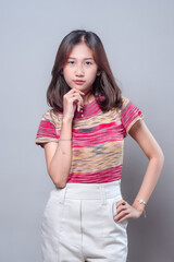 Confident Asian Woman Thinking with Hand on Chin