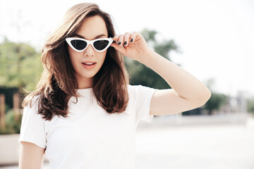 Young beautiful smiling hipster woman in trendy summer white t-shirt and jeans clothes. Sexy...