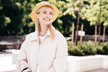 Young beautiful smiling blond woman in trendy summer clothes. Carefree female posing on the street...