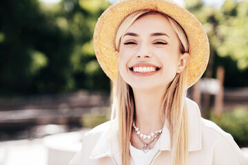 Young beautiful smiling blond woman in trendy summer clothes. Carefree female posing on the street...