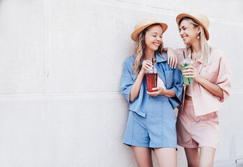 Two young beautiful smiling hipster female in trendy summer clothes. Carefree women posing...