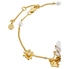 Elegant gold chain bracelet with pearl accents and floral charms close up