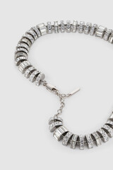 Elegant silver necklace with crystal accents on plain background for fashion