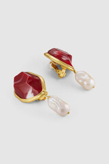 Elegant gold framed earrings featuring red stone and baroque pearl drops