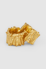 Golden textured earrings stylish fashion jewelry close up still life product shot