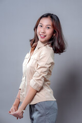 Confident Asian Woman Smiling with Hands Clasped