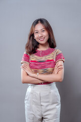 Confident Asian Woman Smiling with Arms Crossed