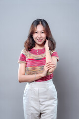 Confident Asian Woman Smiling in Colorful Casual Outfit