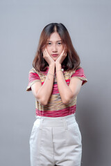 Thoughtful Asian Woman Posing with Hands on Face