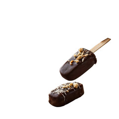 Hand holding chocolate-dipped ice cream bar with almond crunch and drizzle