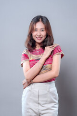Smiling Asian woman with confident and elegant pose in casual outfit
