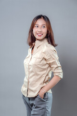 Confident Asian Woman Smiling with Hand in Pocket