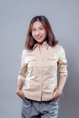 Confident Asian Woman Smiling with Hands in Pockets