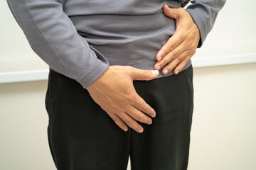 Hernia, Asian man stomach ache, abdominal pain and urology problem health.