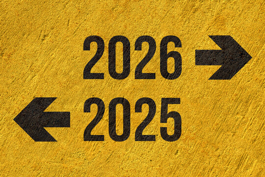 2025 to left 2026 to right painted on yellow concrete wall, new year new way business concept, the past and the future, results and forecasting
