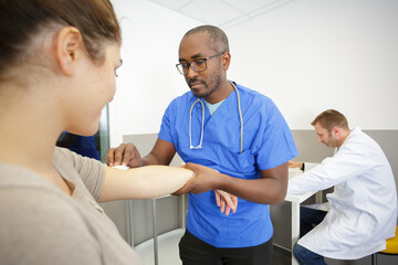 Fototapeta premium doctor using an otoscope to look at his patient