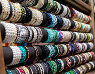Colorful Stacked Gemstone and Pearl Bracelets on Display for Sale