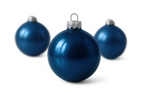 Blue glass christmas ornament in front with two blurry baubles in background, celebrating winter holiday season, transparent background
