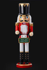 Nutcracker Soldier Toy Ornament With Countdown Sign For Christmas Celebrations, Decorative Winter Holiday Decor, isolated on black background
