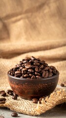 Roasted Coffee Beans in a Bowl on Burlap Fabric.