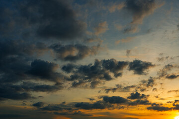 Sunset sky clouds in the Evening with Golden orange sunlight in golden hour, Dusk sky background