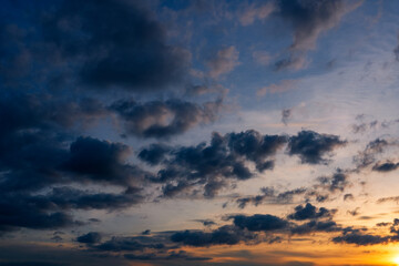 Sunset sky clouds in the Evening with Golden orange sunlight in golden hour, Dusk sky background