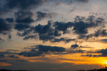 Fototapeta premium Sunset sky clouds in the Evening with Golden orange sunlight in golden hour, Dusk sky background