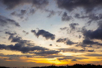 Sunset sky clouds in the Evening with Golden orange sunlight in golden hour, Dusk sky background