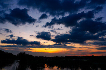 Sunset sky clouds in the Evening with Golden orange sunlight in golden hour, Dusk sky background