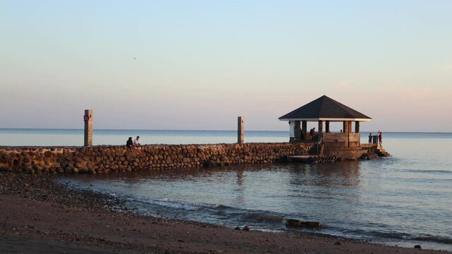 Probolinggo, Indonesia - August 21, 2024: A beautiful stone pier, located on the edge of the beach at Pantai Utama Raya Probolinggo
