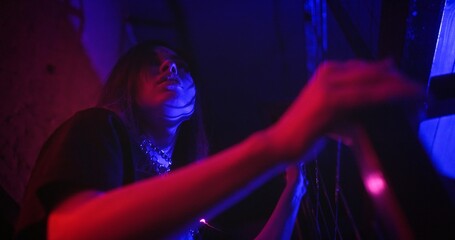 Scared and worried girl runs up the stairs of abandoned building searching for an exit. Low angle tracking shot