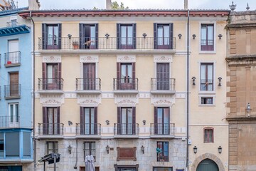 Traditional Residential Facade with Iron Balconies and Wooden Shutters in Old Town Architecture