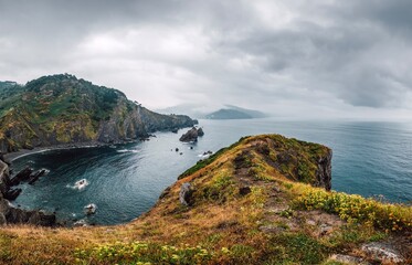 Rugged Gaztelugatxe Cliffs and Peninsula Overlooking Dark Atlantic Ocean on a Cloudy Day