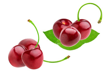 two fresh groups of shiny, ripe red cherries with long curved green stems and small leaves, isolated against a crisp black studio backdrop.