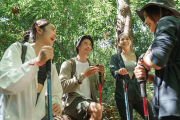 Friends enjoying nature during summer hiking in forest