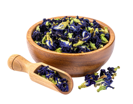 dried butterfly pea flowers placed in a small round wooden bowl isolated