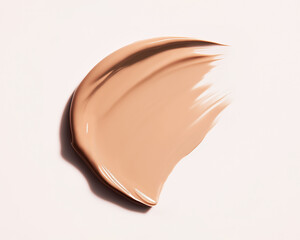 Beige foundation cream swatch with deep shadows on light background. Horizontal texture close-up of liquid tinted moisturiser. Professional studio light, top view